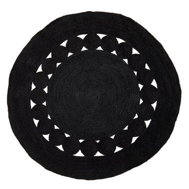 Black round rug with white geometric pattern on a white background