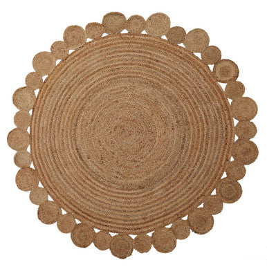Round braided rug with a scalloped edge on a white background