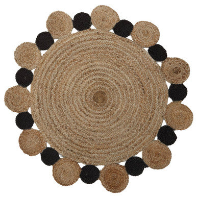 Round jute rug with black and brown circular accents on a white background
