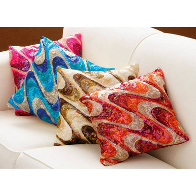 Colorful patterned pillows on a white couch