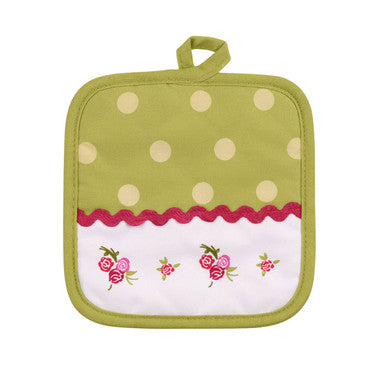 Green pot holder with white polka dots and floral design on a white background