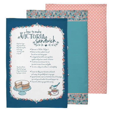 Two tea towels with a recipe for a Victoria sandwich on one, against a white background.