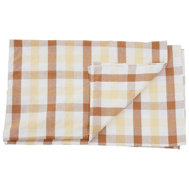 Folded checkered fabric with brown and beige pattern on a white background