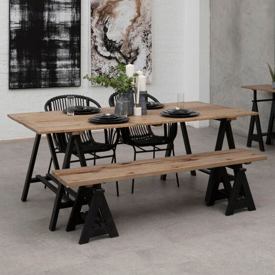 Dining area with wooden tables and benches in a modern interior setting.