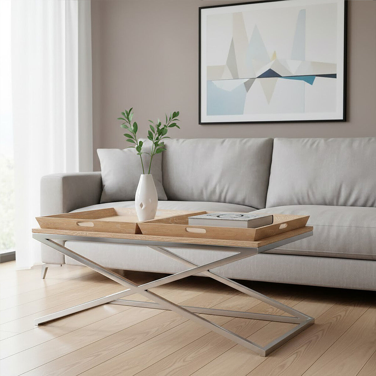 Modern living room with a gray sofa, glass coffee table, and abstract art on the wall.