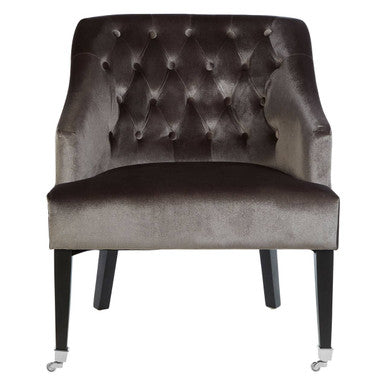 Gray velvet armchair with tufted backrest on a white background
