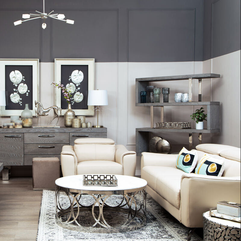 Modern living room with gray walls, white furniture, and decorative elements.