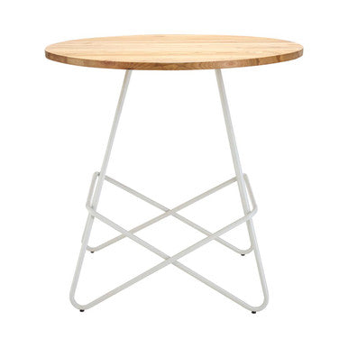 Round wooden table with white metal legs on a white background