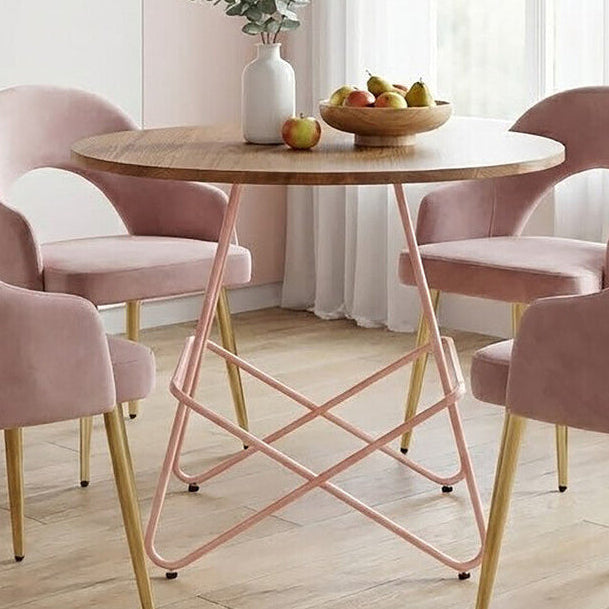 Dining room with a round wooden table and pink chairs in a bright room.