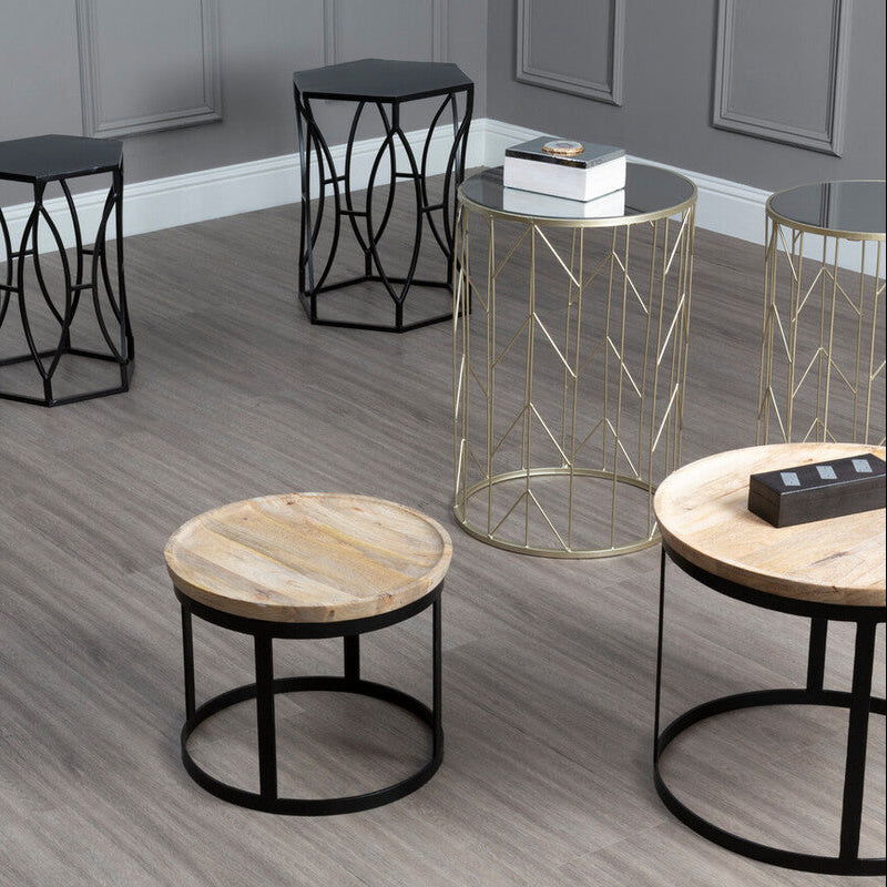Set of modern side tables with different designs on a wooden floor.
