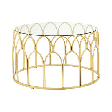 Gold metal coffee table with glass top on a white background