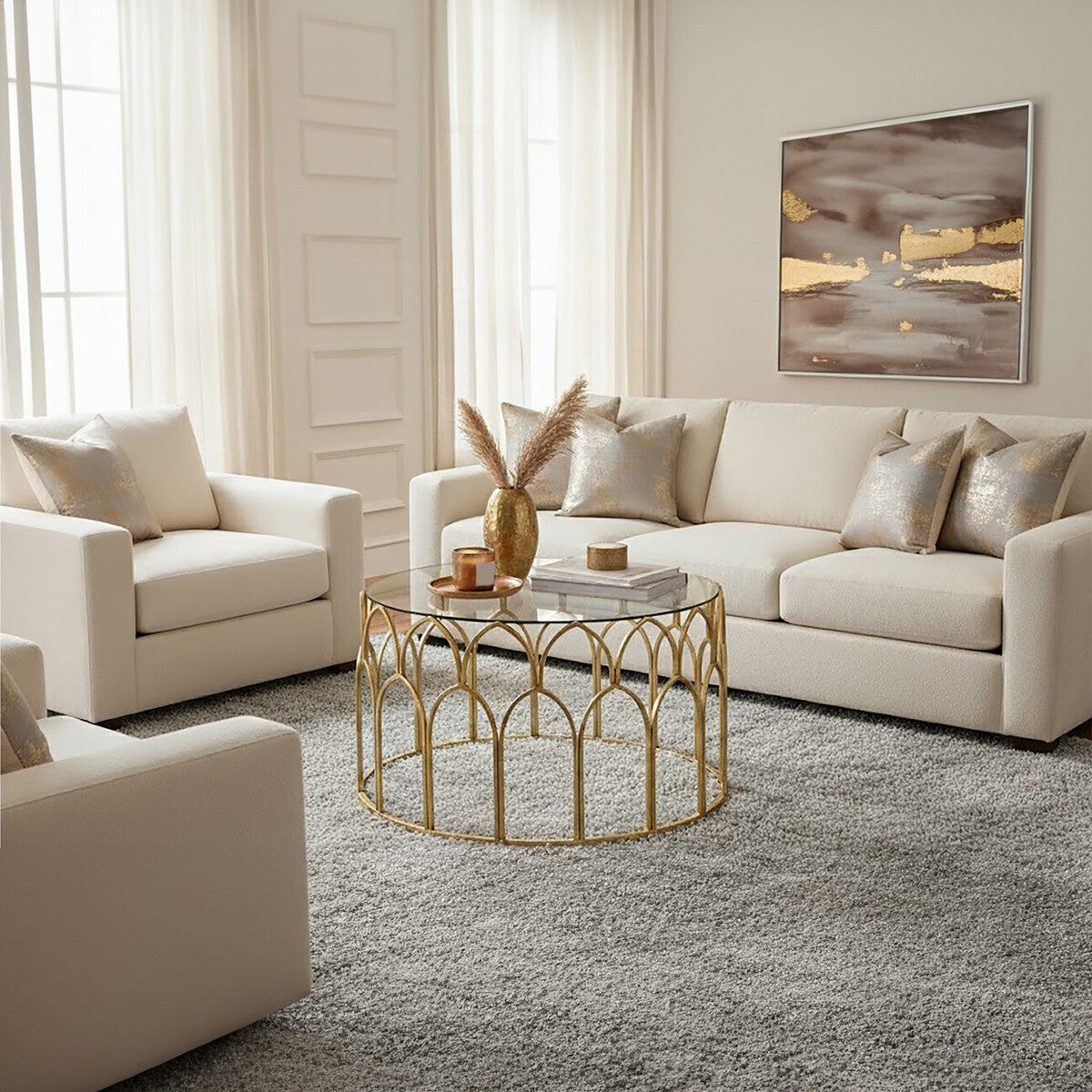 Modern living room with beige sofa, armchair, and gold coffee table.