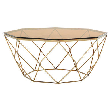 Hexagonal gold metal coffee table with glass top on a white background