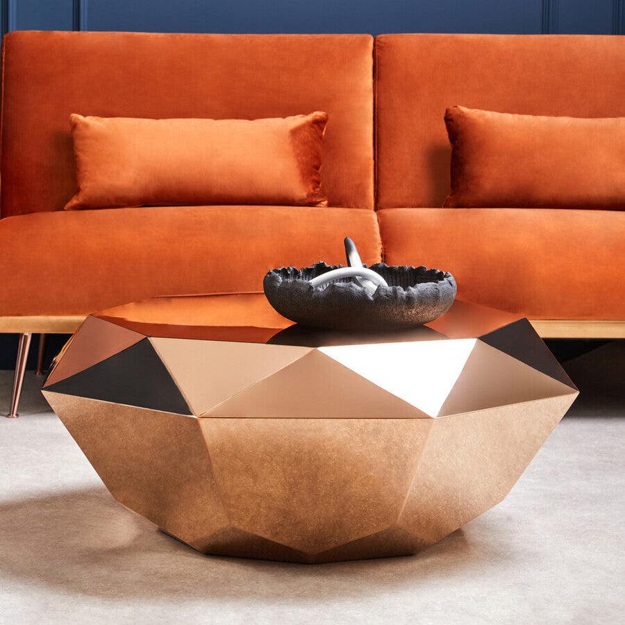 Orange sofa with geometric coffee table against a blue wall
