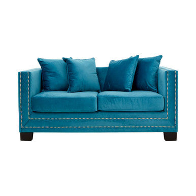 Blue sofa with four cushions on a white background