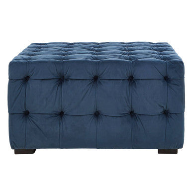 Blue tufted ottoman on a white background
