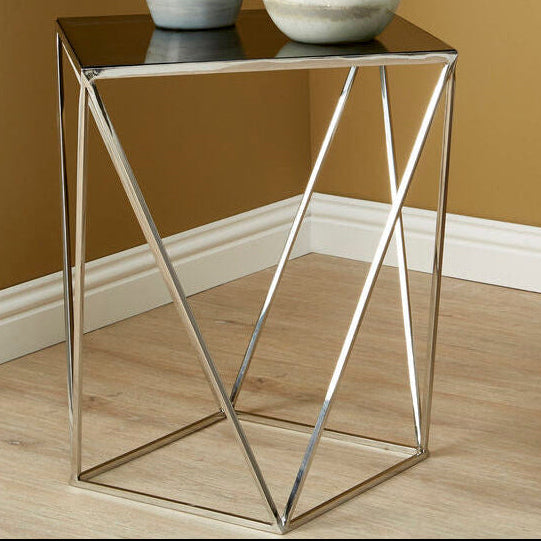 Modern side table with marble vases against a brown wall
