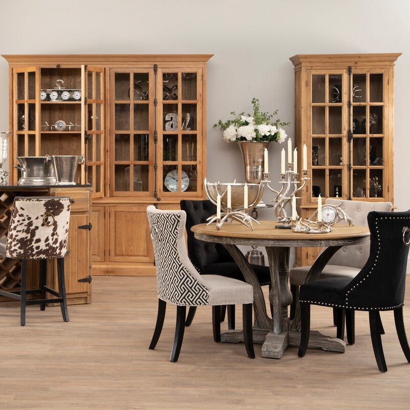 Dining room with wooden furniture including a table, chairs, and cabinets.
