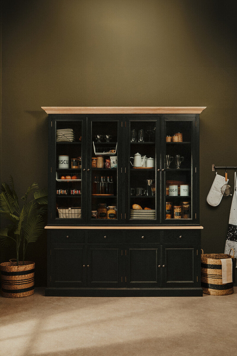 Black cabinet with glass doors against a green wall