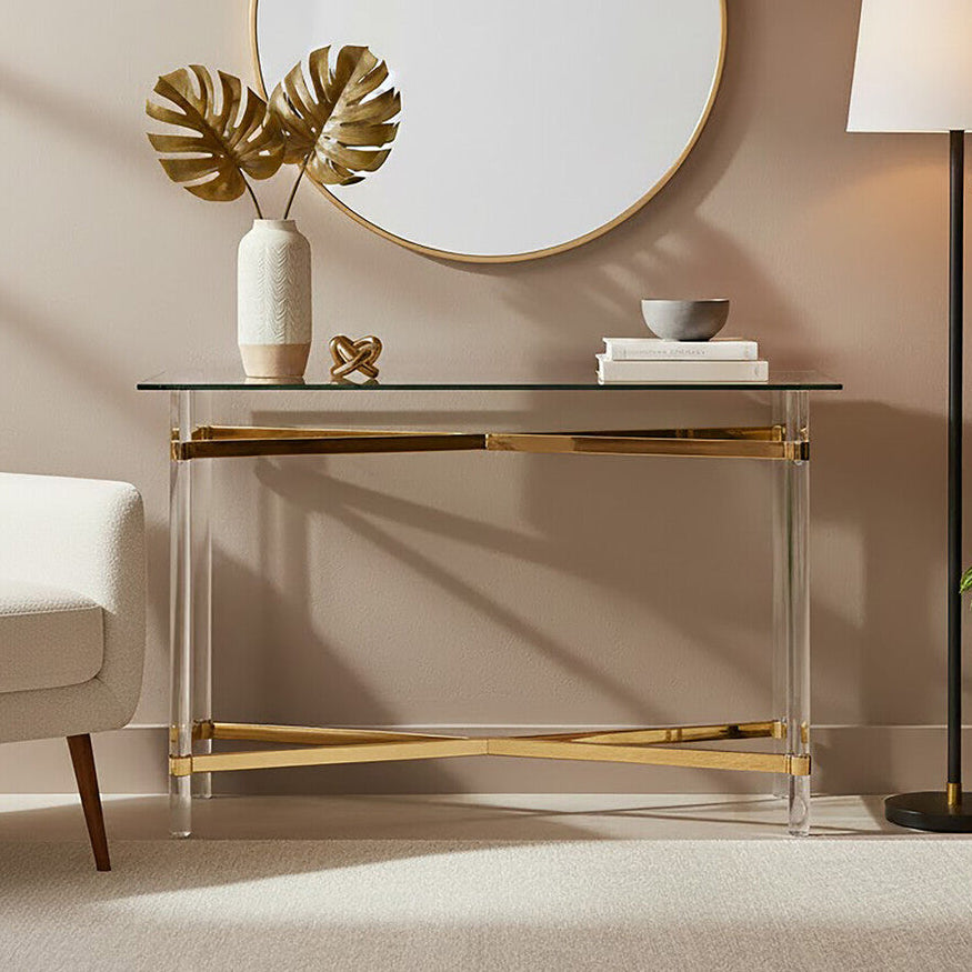 Modern interior with a round mirror, glass console table, and armchair.