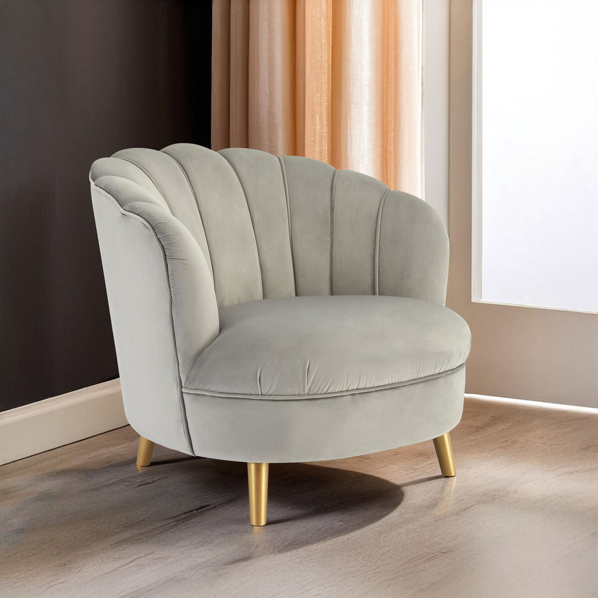 Gray armchair with gold legs in a room with a window and curtains