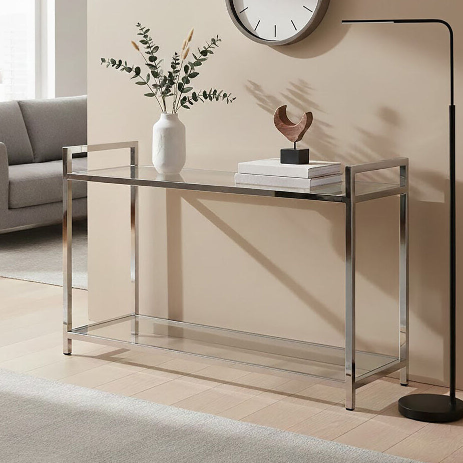 Modern living room with a glass console table, decorative items, and a clock on the wall.