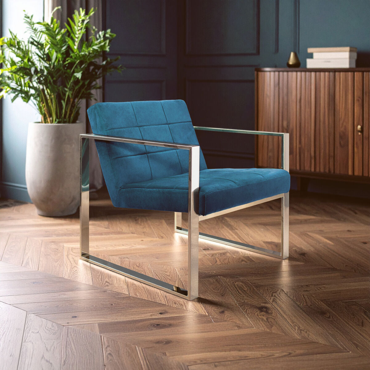 Blue chair with metal frame in a room with wooden floor and plant