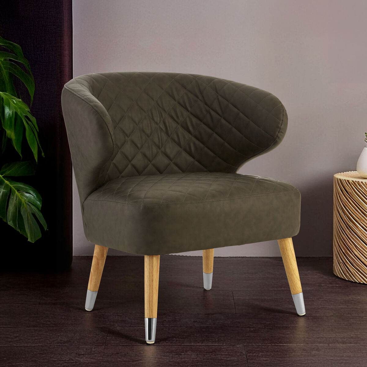 Green armchair with wooden legs in a room setting