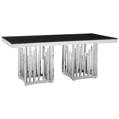 Modern dining table with black glass top and silver metal frame on a white background