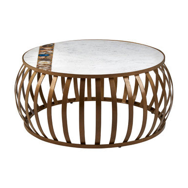 Round coffee table with marble top and bronze metal base on a white background