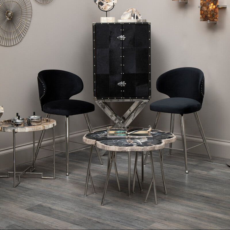 Modern interior with black furniture, marble table, and wall decor.
