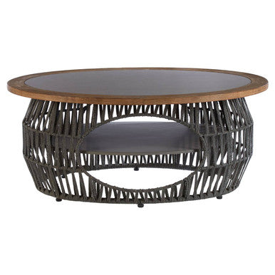 Round coffee table with wicker base and glass top on a white background