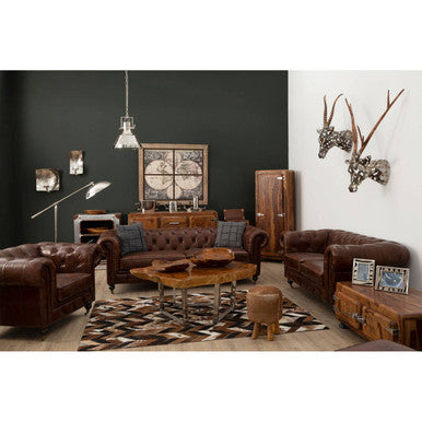 Living room with brown leather furniture, wooden coffee table, and decorative items.