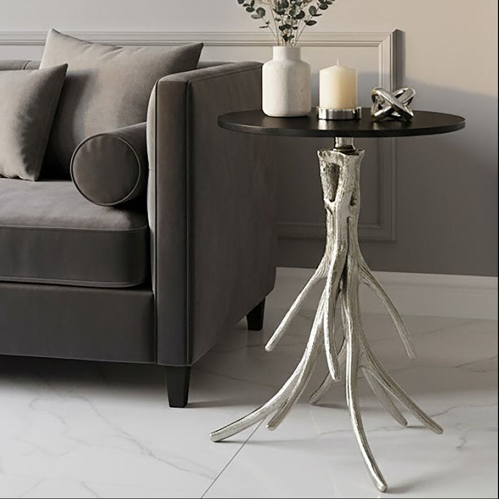 Modern living room with a gray sofa, decorative side table, and wall art.