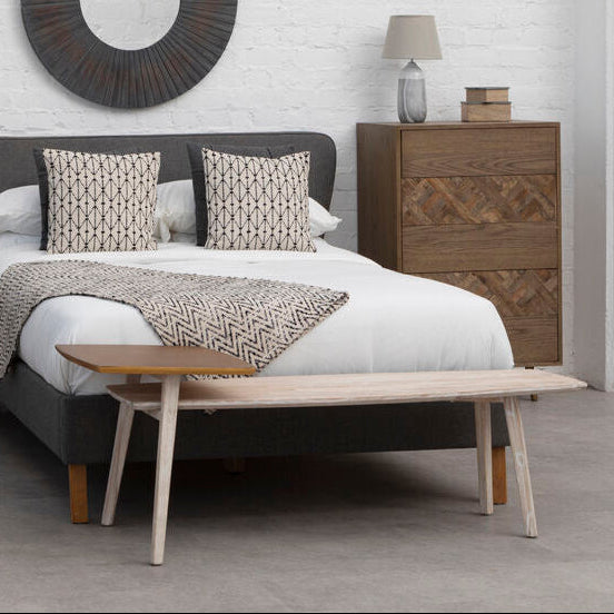 Modern bedroom with a bed, nightstands, and wall mirror.