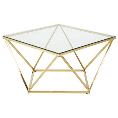 Gold geometric coffee table with glass top on a white background