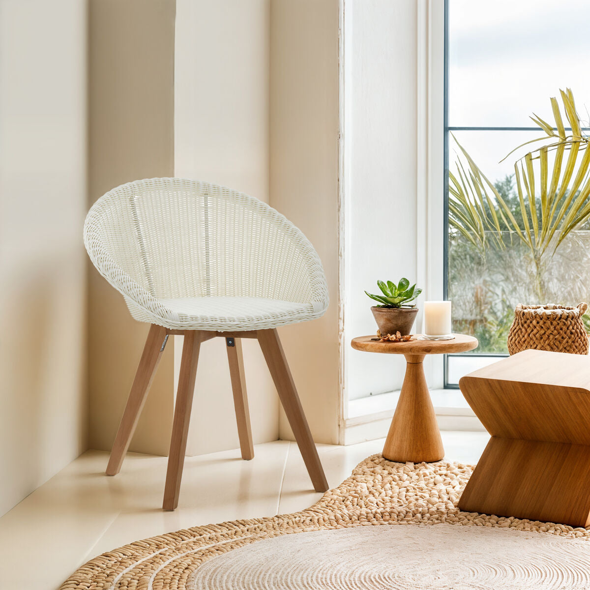 Woven chair in a bright room with a window and decorative items.