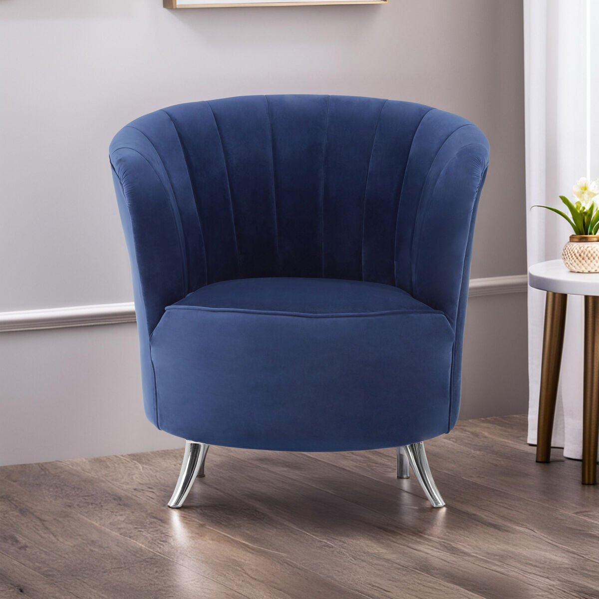 Blue velvet armchair in a room with a neutral color scheme