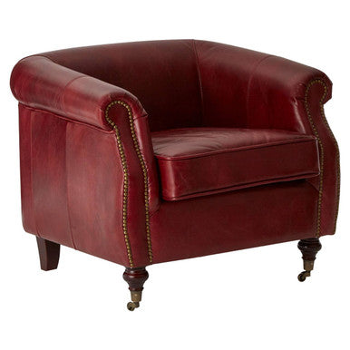 Red leather armchair with nailhead trim on a white background