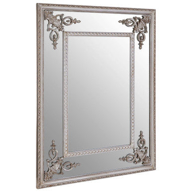 Decorative wall mirror with ornate frame on a white background