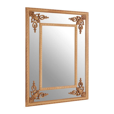 Decorative gold mirror with intricate designs on a white background