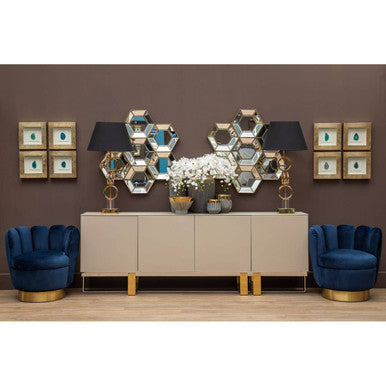 Modern living room with beige sideboard, blue chairs, and decorative wall mirrors.
