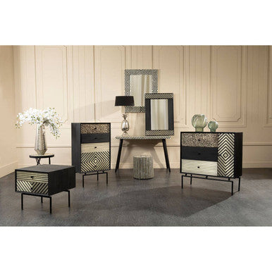 Decorative furniture set with patterned cabinets and mirror in a room with light-colored walls and dark flooring.