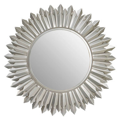 Decorative round mirror with a sunburst design on a white background