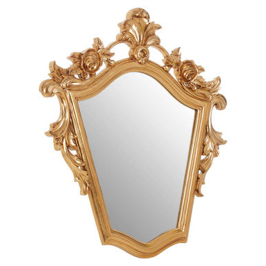 Decorative gold mirror with intricate designs on a white background