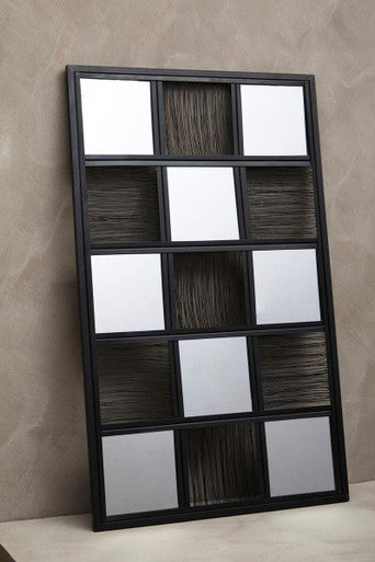 Decorative wall art with a grid of square panels on a beige wall.
