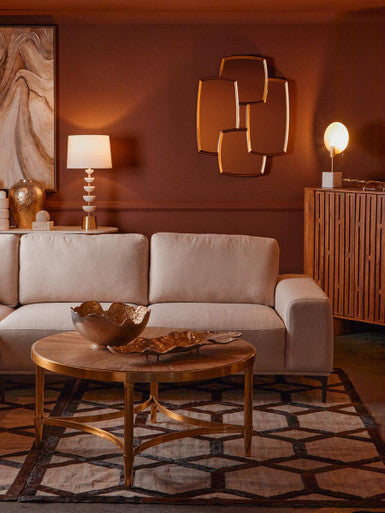 Living room with beige sofa, wooden coffee table, and decorative wall art.