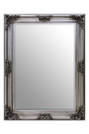 Decorative mirror with an ornate silver frame on a white background
