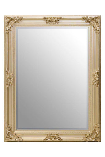Decorative gold-framed mirror on a white background
