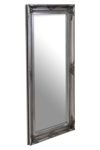 Decorative silver mirror with intricate frame on a white background